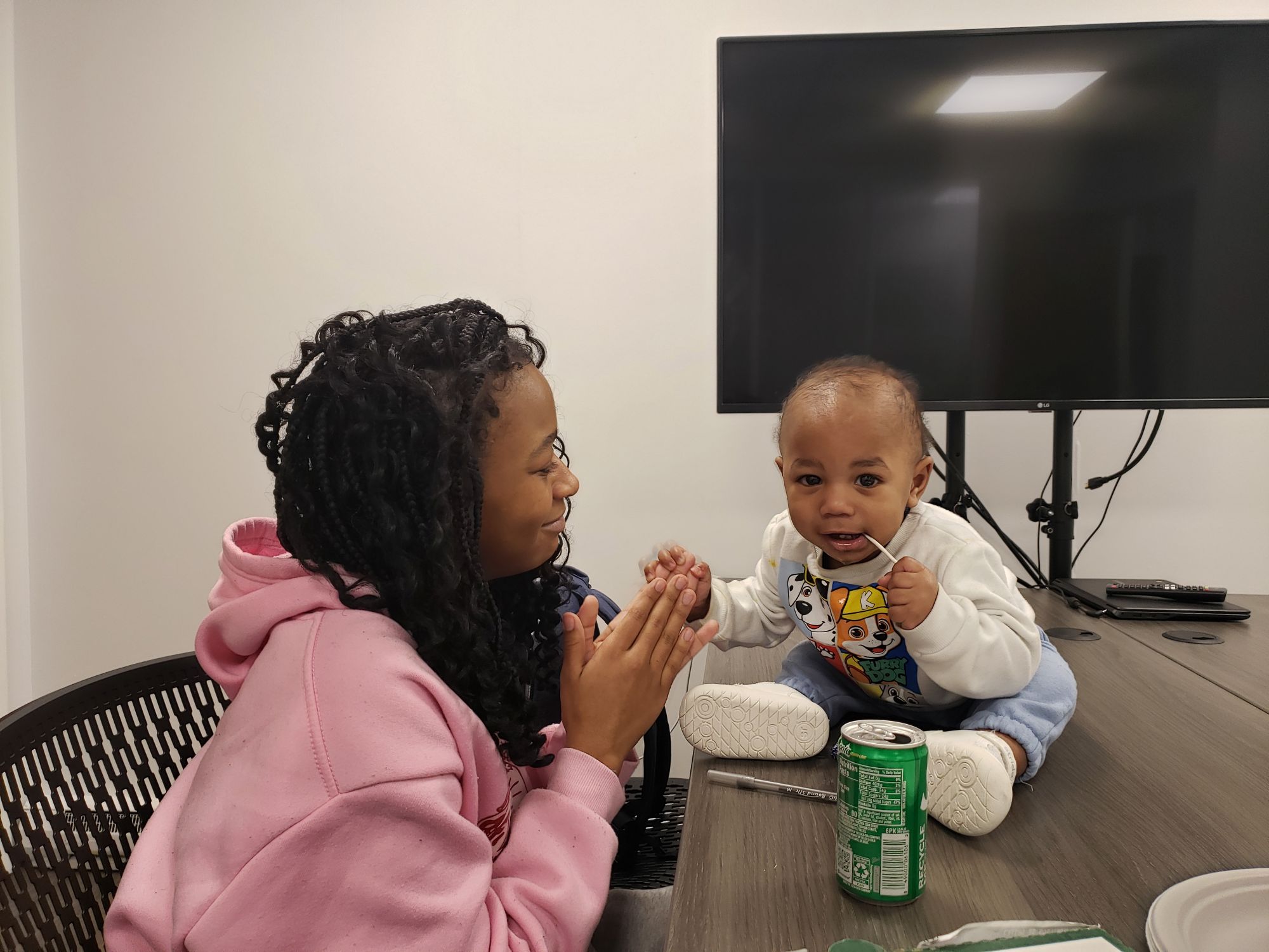 A baby sits on a table while his mother watches at Bright Hope Pregnancy Support Centers.